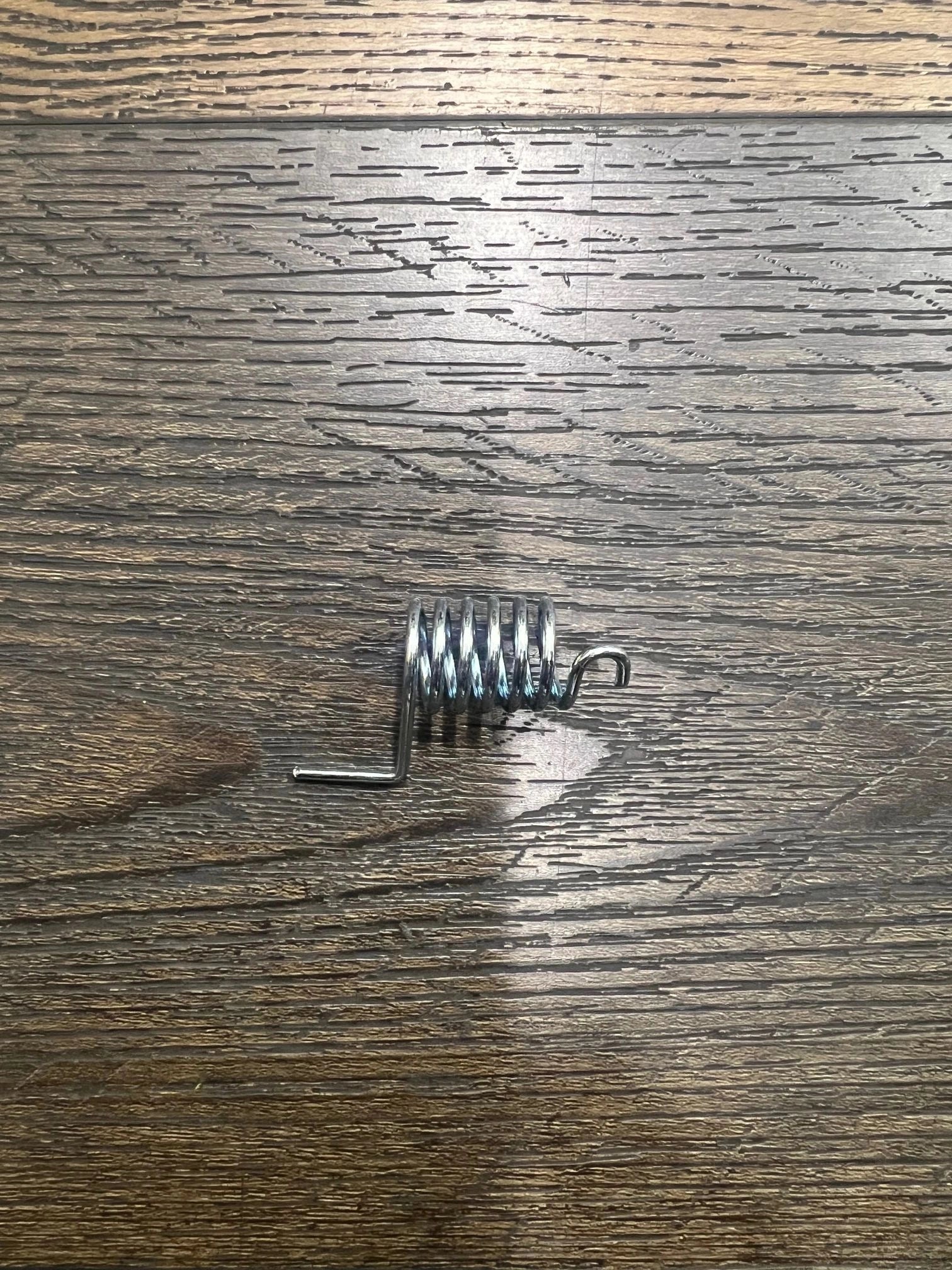 THROTTLE PEDAL RETURN SPRING. L